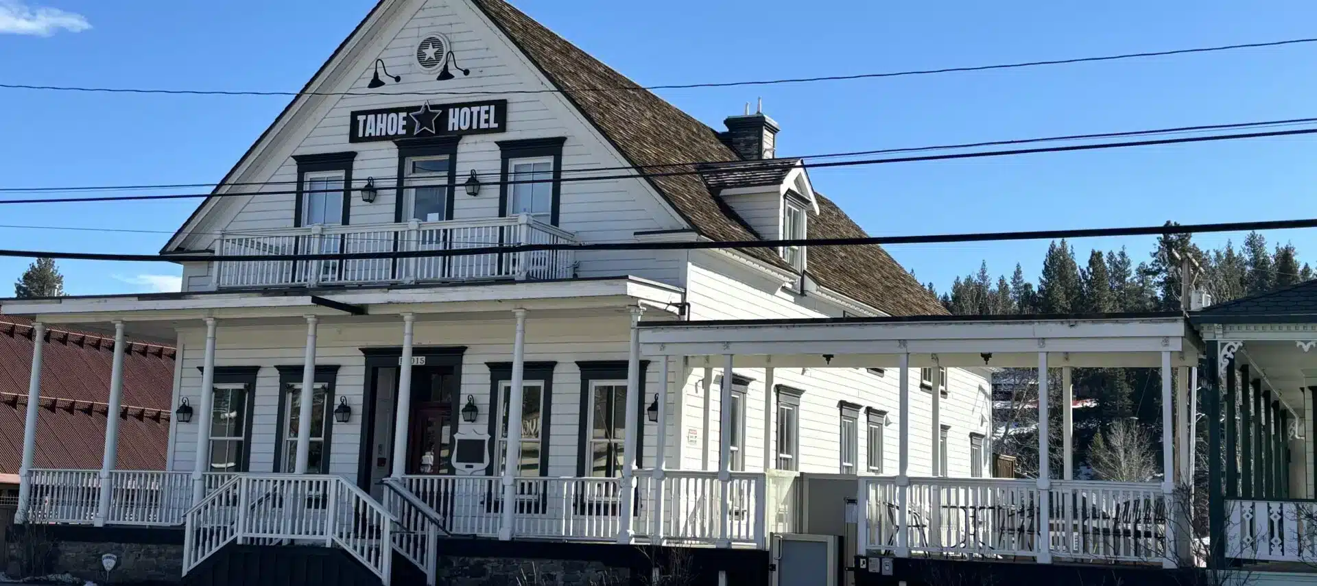 Two-level white building with brown trim, Tahoe Star Hotel sign on front