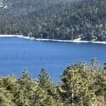 donner lake with snow on the mountains