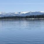 donner lake with the snow on mountain tops