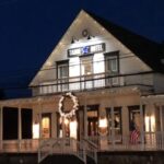 night view of the white building with christmas lights